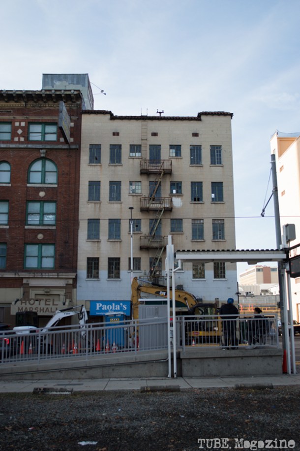 A couple waits for the light rail across from sub-street construction on 7th Street. Photo M.Hershenow. 2014.
