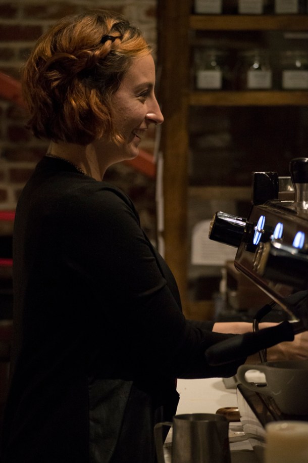 Macaela preps her espresso while talking with a customer. Photo M.Hershenow. 2014.