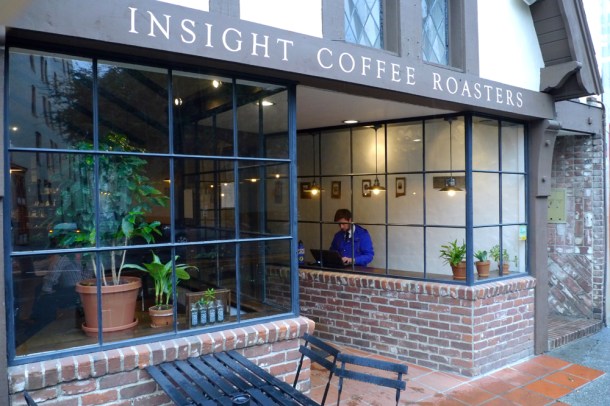 Passersby get a quick peak at Logan Fessler’s “No Past, No Future” exhibit at Insight Coffee Roasters in downtown Sacramento